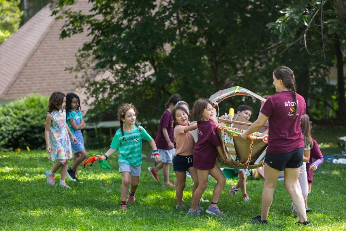 campers carry a handmade boat